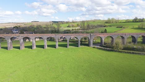 Reveal-drone-footage-of-Welland-Viaduct-Northamptonshire,-also-known-as-the-Harringworth-and-Seaton-Viaduct-over-River-Welland-and-valley-on-sunny-day