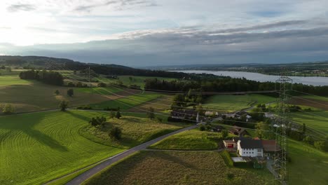 The-serene-greifensee-in-switzerland-with-lush-green-fields-and-a-calm-lake,-aerial-view
