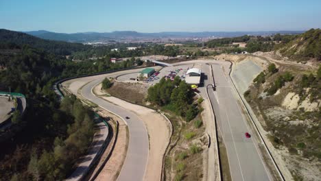 Castelloli-speed-circuit-in-barcelona-on-a-sunny-day,-showing-winding-race-tracks,-aerial-view