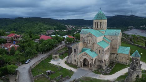 Explore-Bagrati-Cathedral-in-Kutaisi,-Georgia,-from-above-with-4K-60fps-drone-footage,-revealing-its-majestic-presence-and-surrounding-landscape
