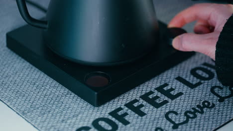 Adjusting-the-Temperature-on-the-black-Barista-Water-Kettle-for-Pour-Over-Coffee-Close-up
