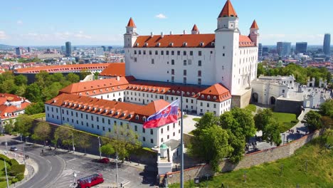 Bratislava-Castle-with-Slovakian-Flag,-Slovakia,-Aerial