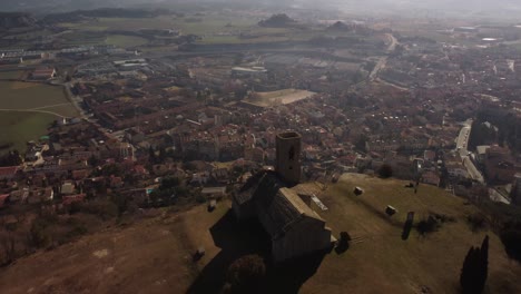 The-hermitage-and-town-of-tona-in-barcelona-with-mountains-in-the-background,-aerial-view