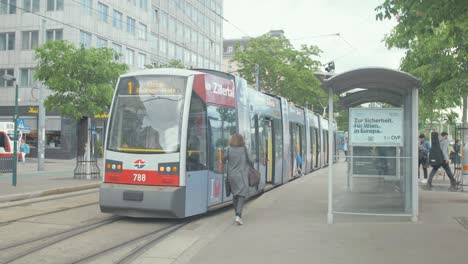 Woman-runs-to-board-the-tram-in-Vienna