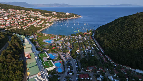 Aerial-view-overlooking-the-Rabac-town-and-resort,-sunset-in-Istria,-Croatia