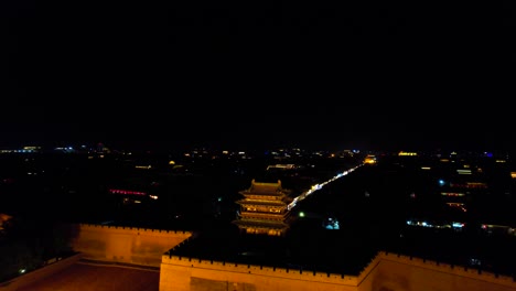 Drone-view-of-people-entering-Pingyao's-Ancient-Town-through-South-Gate-at-night-after-light-show
