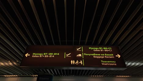 Bilingual-illuminated-information-board-sign,-Bulgarian-airport-lounge