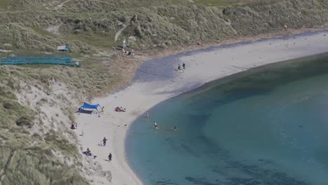 Barley-Cove-Beach-people-enjoying-the-day-on-the-beach---4K-cinematic-drone-footage---Co