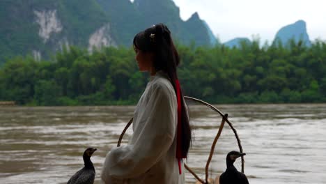 Chinese-girl-fixes-long-hair-on-traditional-fishermen-scene