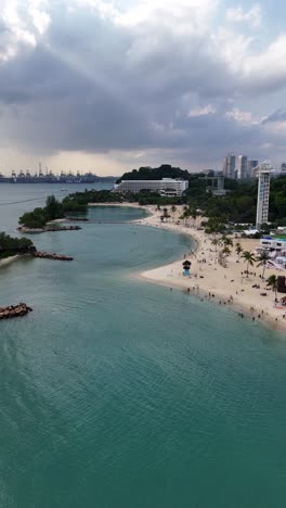 Aerial-flyover-above-the-beautiful-tropical-beaches-of-Sentosa-Island,-Singapore