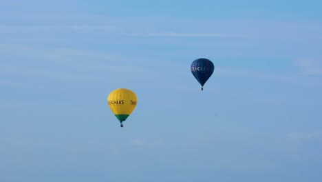 Thatchers-Cider-and-CJ-Hole-Estate-Agents-hot-air-balloons-against-blue-sky-flying-over-the-Somerset-Levels