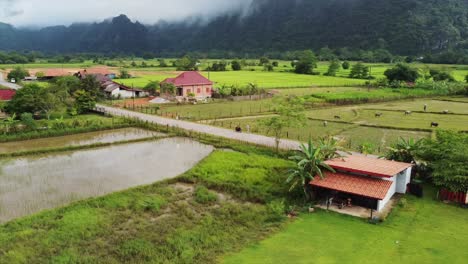 Drone-footage-spinning-to-reveal-the-quaint-village-of-Naka,-nestled-in-the-heart-of-Laos