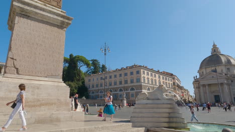 People-Walking-Across-Flaminio-Obelisk-in-Piazza-del-Popolo-Square