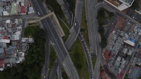 Top-down-drone-shot-of-car-traffic-on-highways-in-Bogota,-Colombia-at-sunset