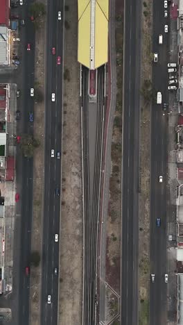 Central-Avenue,-Mexico-City-metro-tracks-in-Ecatepec,-vertical-view