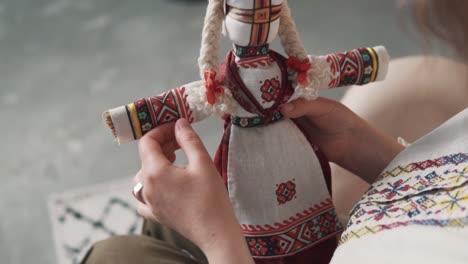 Close-up-of-female-hands-holding-an-authentic-Ukrainian-handmade-motanka-doll