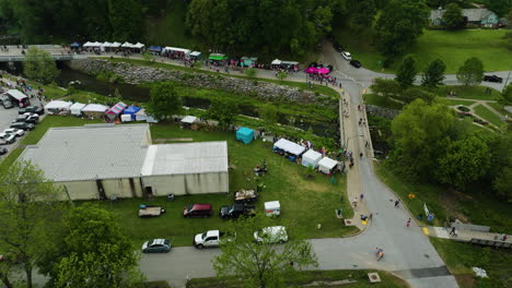 The-50th-anniversary-dogwood-fest-in-arkansas-with-colorful-tents-and-lively-crowd,-aerial-view