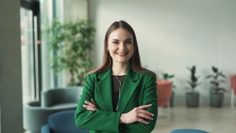 portrait-of-a-beautiful-young-woman-in-business-attire-looking-at-the-camera-and-smiling