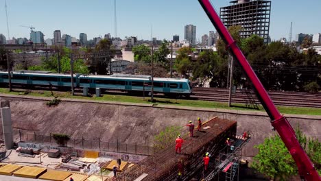 Zug-Fährt-An-Baustelle-Vorbei,-Skyline-Von-Buenos-Aires,-Luft-Push-in