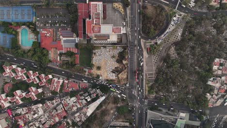 Towering-over-CDMX,-bustling-convergence-of-traffic-and-urban-life-at-its-intersections