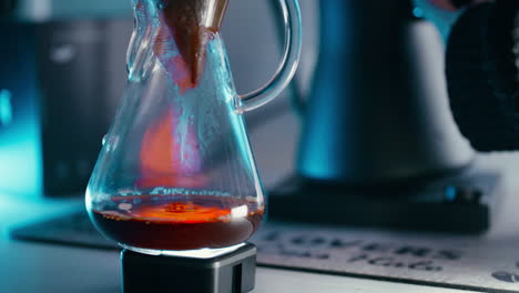Close-up-shot-of-Coffee-dripping-down-the-chemex-through-a-filter-paper-in-slow-motion