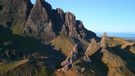 Ancient-crumbling-mountain-with-volcanic-plug-stone-spire-The-Old-Man-of-Storr-and-long-shadows