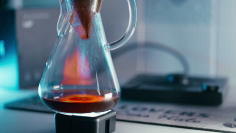Close-up-shot-of-Coffee-dripping-down-the-chemex-through-a-filter-paper-in-slow-motion