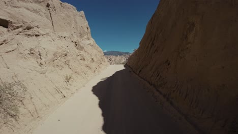 FPV-drone-flying-through-a-canyon-in-the-"Quebrada-de-las-Flechas"-in-Salta,-northeastern-Argentina