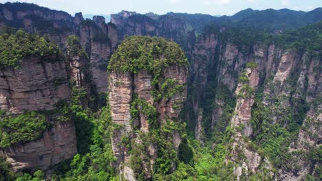 Aerial-orbit-of-towering-rock-formation-at-Yuanjiajie,-in-Zhangjiajie-National-Forest-Park,-China