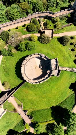 Ascending-aerial-drone-footage-of-castle-moat-and-gardens