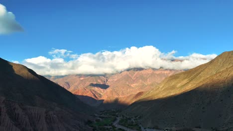 Beautiful-mountain-range-with-clouds-resting-on-its-peaks,-near-Purmamarca-in-Jujuy,-northeastern-Argentina