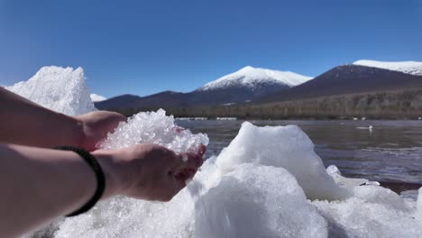 Person-Holding-Ice-Near-Water