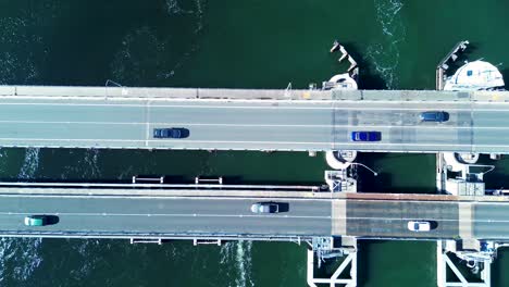 Landscape-shot-of-cars-driving-over-highway-road-bridge-Swansea-channel-Belmont-Lake-Macquarie-boat-inlet-Newcastle-transport-travel-drone-aerial