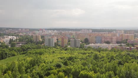 Panoramic-view-of-a-70's-urban-housing-estate-in-Ostrava-behind-a-large-green-area-under-an-overcast-sky