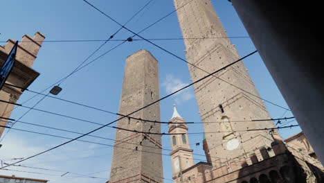 Historic-towers-rise-above-Bologna's-old-cityscape-under-clear-skies