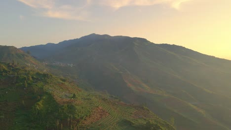 Volcano-Gunung-Prau-in-golden-sunset,-travel-destination-Indonesia-drone-forward
