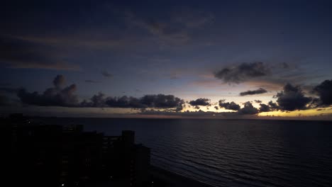 Time-Lapse-Sunrise-Behind-Clouds-Over-The-Ocean