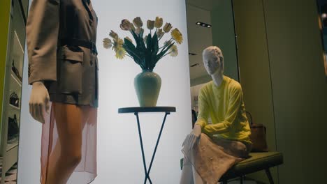 Elegant-fashion-store-window-display-featuring-mannequins-with-stylish-outfits-and-decor