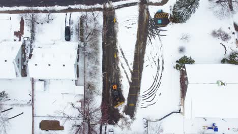 Aerial-View-of-Truck-Clearing-Snow-During-a-April-Snowstorm-in-Longueuil,-Canada