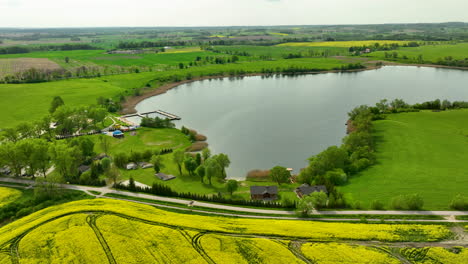 Aerial-view-of-a-small-lakeside-village-with-houses-and-greenery-surrounding-the-water