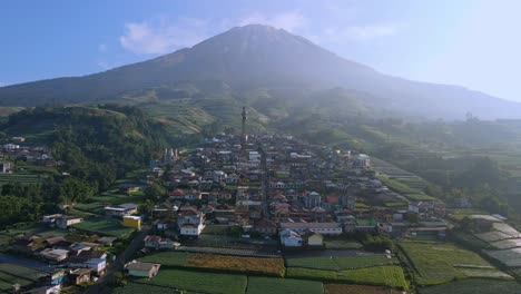 Aerial-forward,-small-poor-rural-village-on-the-slope-of-mount-Sumbing