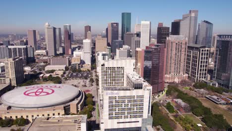 Houston-TX-USA,-Aerial-View-of-Downtown-Towers-and-Toyota-Center-Arena,-Establishing-Drone-Shot