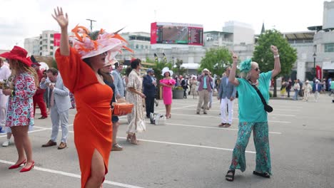 Two-women-dancing-joyfully-at-a-tailgate-party-at-Churchill-Downs,-celebrating-before-the-150th-Kentucky-Derby