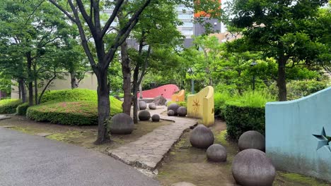 Playground-area-with-colorful-walls-and-trees-in-a-peaceful-park-on-a-cloudy-day