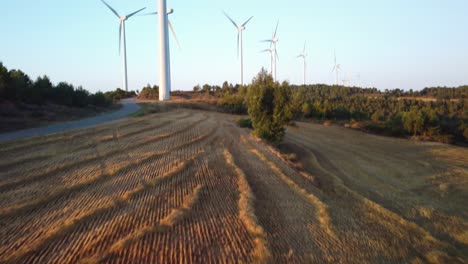Golden-fields-and-distant-windmills-in-Igualada,-Barcelona-during-sunset