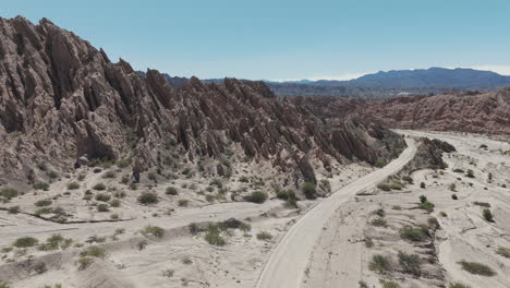 Ruta-40-gravel-road,-passing-through-the-stunning-geological-formation-known-as-Quebrada-de-las-Flechas