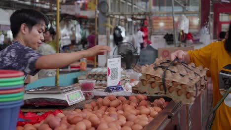 Indoor-market,-sellers,-stalls,-customers,-poultry-eggs,-slow-motion