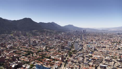 Drone-shot-of-downtown-Bogota,-Colombia-from-afar-on-sunny-day