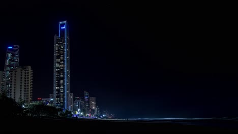 Timelapse-of-buildings-on-the-Gold-Coast-taken-from-the-beach-at-night-with-mist-and-waves-crashing