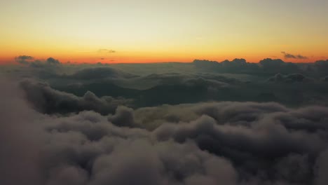 Flight-above-massive-clouds-with-horizon-in-background-on-high-altitude
